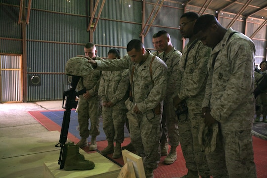 A group of Marines with 1st Maintenance Battalion (-) (Reinforced), 1st Marine Logistics Group, pay their final respects to Lance Cpl. Stacy Ann Dryden during a memorial ceremony here, Oct. 27. Many of those present at the ceremony reflected on Dryden’s positive attitude and her openness as a friend who was always willing to listen to others and help them out in times of need. Dryden, 22, from North Canton, Ohio, was serving in Iraq as a preservation, packaging and packing specialist when she died Oct. 19 from a non-combat related incident in al Anbar Province, Iraq.
