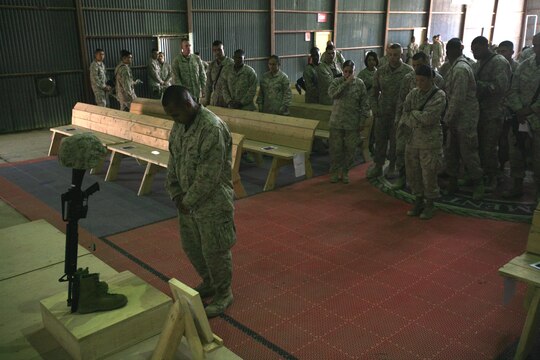 A group of Marines with 1st Maintenance Battalion (-) (Reinforced), 1st Marine Logistics Group, wait to pay their final respects to Lance Cpl. Stacy Ann Dryden during a memorial ceremony here, Oct. 27. Many of those present at the ceremony reflected on Dryden’s positive attitude and her openness as a friend who was always willing to listen to others and help them out in times of need. Dryden, 22, from North Canton, Ohio, was serving in Iraq as a preservation, packaging and packing specialist when she died Oct. 19 from a non-combat related incident in al Anbar Province, Iraq.