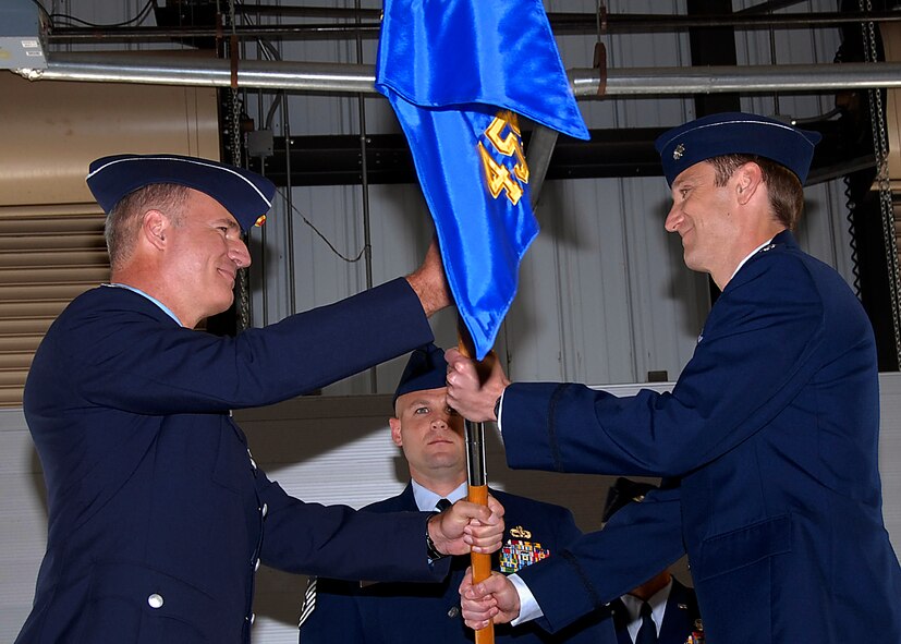 German air force Col. Axel Pohlmann, 80th Operations Group commander, passes the squadron guidon to Lt. Col. Scottie Zamzow, the first commander of the 459th Flying Training Squadron, at the 459th FTS reactivation ceremony April 17. The squadron was reactivated to alleviate congestion in the 89th FTS. (U.S. Air Force photo/Harry Tonemah)