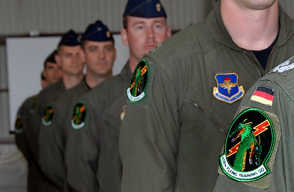 Members of the 459th Flying Training Squadron wear the squadron patch for the first time at the 459th FTS reactivation ceremony April 17. The new squadron was reactivated to alleviate congestion in the 89th FTS. (U.S. Air Force photo/Harry Tonemah)