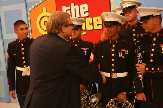 Drew Carrey, a former Marine sergeant and the host of CBS's "The Price is Right," shakes hands with members of the 3rd Marine Aircraft Wing Band during their visit to the show for the Veterans Day "Salute to the Military" episode, Aug. 11. The band played each of the service branchs' songs and "Stars and Stripes Forever" during the show's taping.(Official U.S. Marine Corps photo by Cpl. Christopher O'Quin)