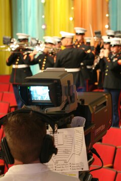 Eddie Nelson, a cameraman with CBS Studios, films Marines from the 3rd Marine Aircraft Wing Band as they play the "Marines Hymn,"  for the Veterans Day "Salute to the Military" episode of CBS's "The Price is Right," Aug. 11, in Los Angeles. This episode marked the second time the band has performed for the show.  (Official U.S. Marine Corps photo by Cpl. Christopher O'Quin)