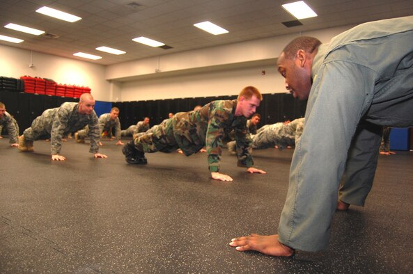 Tech. Sgt. Rudolph Stuart (right), instructor in the Air Force Phoenix Raven Training Course, talks to students on Feb. 19 during a training session in the U.S. Air Force Expeditionary Center on Fort Dix, N.J.  The Raven course, taught by the USAF EC's 421st Combat Training Squadron, teaches security forces Airmen specialized training in aircraft security, combatives and verbal judo to name a few.  (U.S. Air Force Photo/Tech. Sgt. Scott T. Sturkol)