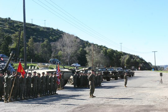 Marines from Headquarters Battalion, 1st Marine Division, stand at parade rest in front of various trucks and tanks Master Gunnery Sgt. James C. King, motor transport chief, 1st Marine Division, restored. King plans to keep volunteering at the Marine Corps Base Camp Pendleton Mechanized Museum past his retirement ceremony Friday.