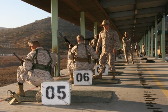 Cpl. Josh Farrell, a combat marksmanship coach with the Carlos Hathcock Range Complex at Marine Corps Air Station Miramar, observes shooters to make sure they are using the fundamentals of combat marksmanship and following the proper safety procedures at the range, October 21. Marine coaches help Marines qualify with both the M-16-A2 rifle and M-9 pistol.   (U.S. Marine Corps photo by Lance Cpl. Christopher O'Quin) (Released)