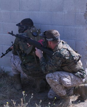 Marines prepare to fire at the opposing team during the Warrior Day Challenge at the Combat Town in Camp Pendleton. The Marines participated in five scenarios during the all-day event, each one more becoming more difficult. The Marines were tested on their teamwork and leadership skills.