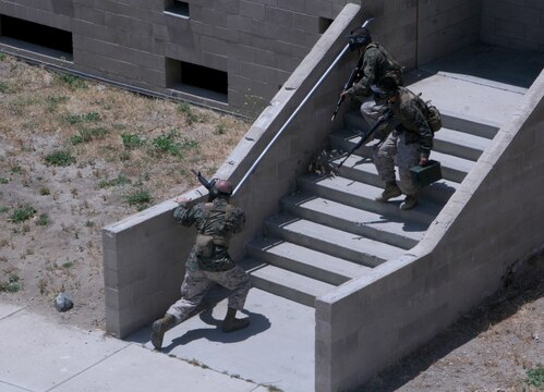 Marines get ready to fire their Airsoft weapons at the opposing team during the Warrior Day Challenge at the Combat Town in Camp Pendleton. The Marines participated in five scenarios during the all-day event, each one becoming more difficult. The Marines were tested on their teamwork and leadership skills.