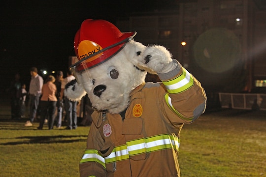 Sparky the fire dog patrols the Matthew C. Perry soccer field here during the annual M.C. Perry Fall Festival Oct. 16, interacting and taking photographs with the children to encourage fire safety. He has been the official mascot of the National Fire Protection Association since 1951.