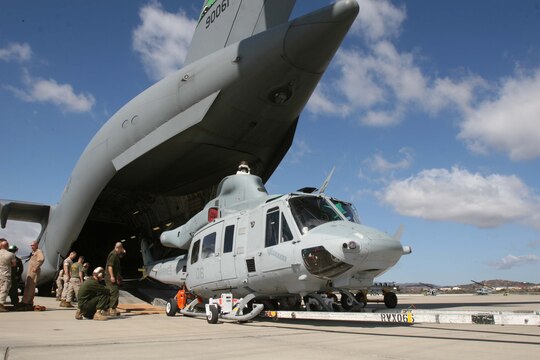 Marines with Marine Light Attack Helicopter Squadron 367, Marine Aircraft Group 39, 3rd Marine Aircraft Wing, I Marine Expeditionary Force, load a UH-1Y "Venom" onto a C-17 "Globemaster" III for transport to Afghanistan aboard Marine Corps Air Station Camp Pendleton, Oct. 20. The squadron is the first to deploy with the new aircraft to Afghanistan.  (Official U.S. Marine Corps photo by Cpl. Christopher O'Quin) (Released)