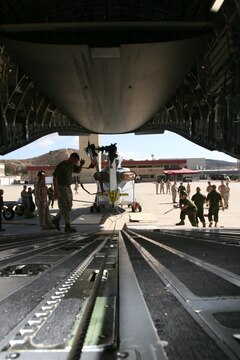 Marines with Marine Light Attack Helicopter Squadron 367, Marine Aircraft Group 39, 3rd Marine Aircraft Wing, I Marine Expeditionary Force, prepare to tow a UH-1Y "Venom" onto a C-17 "Globemaster" III aboard Marine Corps Air Station Camp Pendleton, Oct. 20, for transport to Afghanistan. The Marines will load pairs of the aircraft on other C-17's in the near future for deployment.  (Official U.S. Marine Corps photo by Cpl. Christopher O'Quin)(Released)