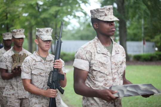Marine representatives carry pieces of a killed-in-action memorial to be placed on stage during a 9/11 remembrance ceremony at Lejeune Memorial Gardens Sept. 11. The ceremony centered around the National Moment of Silence held to honor victims of the attacks.