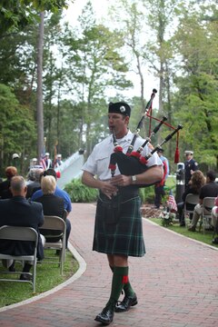 Adam Snyder, fire chief of the Atlantic Beach Fire Department, plays "Amazing Grace" on the bagpipes during a  9/11 remembrance ceremony at Lejeune Memorial Gardens Sept. 11. The ceremony represented civilians, firemen, policemen and service members who had lost their lives during the attack and in Operations Iraqi and Enduring Freedom.