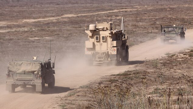 The first Mobile Modular Command and Control vehicle (center), or M2C2, completes its final rounds of integration testing at the Marine Corps Tactical Systems Support Activity at Camp Pendleton Sept. 23. The M2C2 is the first of three and is expected to deploy to Afghanistan this fall.::r::::n::