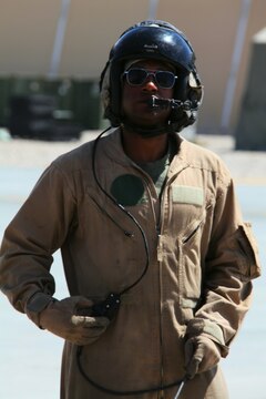 Sgt. Richard Ryan, an MV-22 Osprey crew chief with Marine Medium Tiltrotor Squadron 261, 3rd Marine Aircraft Wing (Forward) here, talks to pilots as he inspects an MV-22 Osprey before flight.