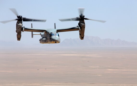 An MV-22 Osprey with Marine Medium Tiltrotor Squadron 261, 3rd Marine Aircraft Wing (Forward), Camp Bastion, Afghanistan, flies over the baron landscape of the Aghanistan desert delivering personnel and cargo, April 24.