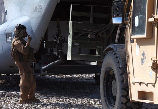 Sgt. Richard Ryan, with Marine Medium Tiltrotor Squadron 261, 3rd Marine Aircraft Wing (Forward), directs a forklift, April 24, as the Marines load cargo onto an MV-22 Osprey just outside of a forward operating base in Afghanistan.