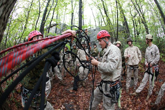 Special Operations Training Group instructors, Capt. Robert Long and Sgt. Jesse Bennett, explain rope installation during a casualty evacuation class during the Assault Climbers Course at Lower Cliff  in Kingwood, W.Va., April 26, 2010. The class learned different techniques for moving themselves and others quickly over man-made and natural occurring objects. The Assault Climbers Course is one of several Special Operations Training Group, II Marine Expeditionary Force events as part of 26th MEU's preparation for deployment this fall. (Official USMC photo by Staff Sgt. Danielle M. Bacon) ::r::::n::
