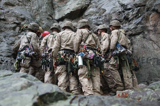 Marines with 26th Marine Expeditionary Unit gather at the base of cliff during a class at the Assault Climbers Course at Lower Cliff in Kingwood, W.Va., April 26, 2010. The class learned different techniques for moving themselves and others quickly over man-made and natural occurring objects. The Assault Climbers Course is one of several Special Operations Training Group, II Marine Expeditionary Force events as part of 26th MEU's preparation for deployment this fall. (Official USMC photo by Staff Sgt. Danielle M. Bacon) ::r::::n::