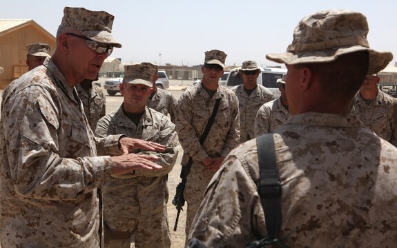 Commandant of the Marine Corps Gen. James Conway (left) speaks to a Marine with 9th Engineer Support Battalion, 1st Marine Logistics Group (Forward), at Camp Leatherneck, Afghanistan, Aug. 20. During their tour, Conway and Sergeant Major of the Marine Corps Carlton Kent received briefs on some of 9th ESB's capabilities including fuel, water purification, utilities and explosive ordnance disposal.