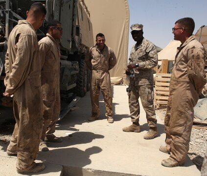 Sergeant Major of the Marine Corps Carlton Kent (second from right) speaks to Marine mechanics at the Combat Logistics Regiment 15 (Forward) Intermediate Maintenance Activity lot during a walking tour at Camp Leatherneck, Afghanistan, Aug. 20. Kent and Commandant of the Marine Corps Gen. James Conway toured the repair warehouse where the mechanics are able to completely rebuild IED-damaged tactical vehicles in under a month.