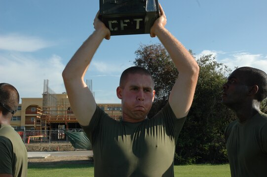 Recruit Benjamin Guenther, platoon 2125, pushes out his last few ammunition can lifts before his two-minute time limit runs out during the combat fitness test here, Aug. 26.