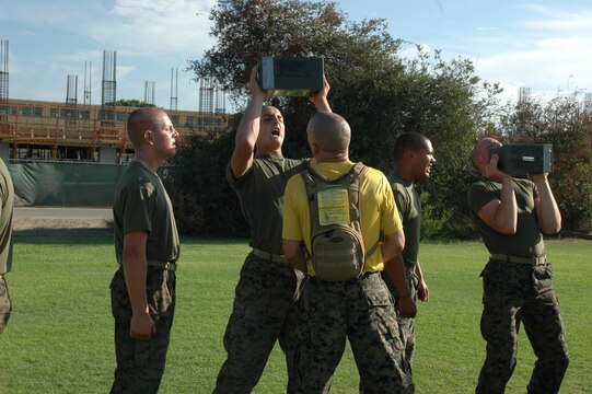 Sgt. Justin Park, drill instructor, platoon 2128, Company F, 2nd Recruit Training Battalion, gives some encouraging words to his recruits as they perform ammunition can lifts here, Aug. 26.