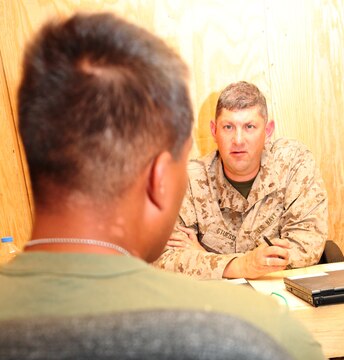 Cmdr. Keith Stuessi, a family physician with Combat Logistics Regiment 15 (Forward), 1st Marine Logistics Group (Forward), consults with a concussion patient at the Concussion Restoration Care Center at Camp Leatherneck, Afghanistan, Aug. 26. The clinic opened Monday and is a first-of-its-kind facility in Helmand Province that was developed to aid in the treatment of concussions