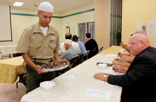 Navy Lt. j.g. Asif. I. Balbale, Islamic chaplain, Amphibious Assault Schools Battalion, Camp Pendleton, offers dates to partakers during an iftar ceremony conducted at base’s South Mesa Chapel, Aug. 31. An iftar is a ritual for Muslims, enjoyed in a family or community setting that celebrates the Islamic holy period of Ramadan.