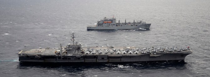 USS George Washington (CVN 73) and USNS Carl Brashear (T-AKE 7) conduct a replenishment-at-sea in waters west of the Korean Peninsula, on Dec. 2, 2010. George Washington completed a training exercise with the Republic of Korea (ROK) navy demonstrating the U.S. commitment to the ROK and regional partners in the Western Pacific. (U.S. Navy photo by Mass Communication Specialist 3rd Class Charles Oki)