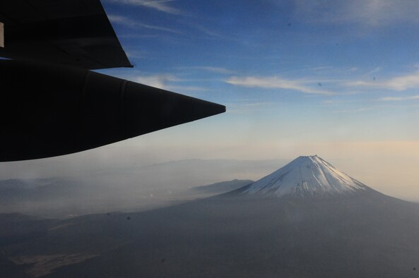 A Yokota Air Base C-130 Hercules passes Mt. Fuji, Japan, during a media flight Dec. 6 as part of exercise Keen Sword. More than one dozen members of the international media were treated to a low-level, "nap-of-the-Earth" orientation and a first-hand witnessing of airdrop operations. Afterward, the C-130 flew over the Sea of Japan, where dozens of fighters from both the U.S. and Japan have been training since the exercise kicked off Dec. 3. (U.S. Air Force photo/1st Lt. Bryan Bouchard) 

