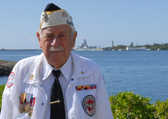 Delton "Wally" Walling, 89, was a Navy 2nd Class Signalman during the Dec. 7, 1941, attacks on Pearl Harbor. He was in the shipyard water tower when the first Japanese bomb dropped on Ford Island (in background). U.S. Air Force photo by Staff Sgt. Carolyn Viss