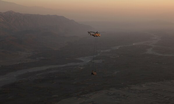 A CH-53E Super Stallion with the Marine Heavy Helicopter Squadron 361 returns to Forward Operating Base Jalalabad, Afghanistan to deliver a disabled H-47 Chinook for repairs Dec. 10.  The Flying Tigers, based out of Camp Bastion, flew across the country to conduct the mission.  Their Super Stallions are the only aircraft in country capable of a 23,500 pound external lift.