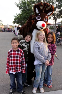 Camp Pendleton children pose with Rudolph the red-nosed reindeer during the annual Winter Wonderland Festival at the Abby Reinke Center, Dec. 15. During the event, guests took photos with Santa Claus, danced with the Gingerbread Man, enjoyed free snacks, played games to win prizes and rode on a holiday express train.