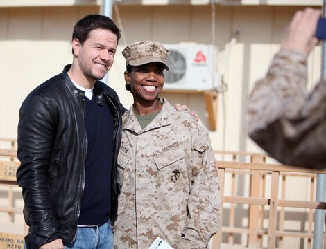 Maj. Rhonda Martin, assistant chief of staff, G-1, Headquarters, 1st Marine Logistics Group (Forward), takes a photo with actor Mark Wahlberg during Wahlberg's visit to Camp Leatherneck, Afghanistan, Dec. 19. Wahlberg shook hands and took pictures with service members while thanking them for their service. More than 100 anxious fans waited in line to meet Wahlberg.