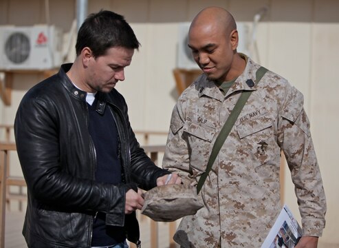 Actor Mark Wahlberg signs a autograph for a sailor at Camp Leatherneck, Afghanistan, Dec. 19. Wahlberg shook hands and took pictures with service members while thanking them for their service. More than 100 anxious fans waited in line to meet Wahlberg.