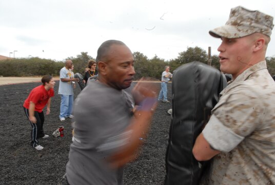 Keith Copeland, Athletic Director, Summit Leadership Academy, Hesperia, Calif., delivers elbow strikes with speed and intensity to his partner Sgt. Wayne Edimiston, media NCO, Public Affairs Office, MCRD San Diego, during the hands-on portion of the Marine Corps Martial Arts Program demonstration.