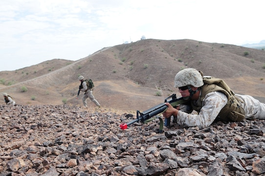 Cpl. Ricardo Montanez, Marine Air Control Squadron 1 navigational aid technician, provides security while his squad moves forward during a corporals course July 27, 2010, at the Marine Corps Air Station in Yuma, Ariz. The squad’s movements lead it to a simulated terrorist outpost which the squad then had to attack. The attack was the culmination exercise for the course focusing on small-unit combat leadership instead of drill and tradition.