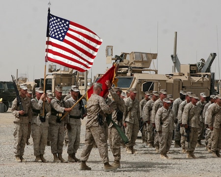 Sergeant Maj. Tracy Linch, the battalion sergeant major for Combat Logistics Battalion 2, 1st Marine Logistics Group (Forward) and Lt. Col. Brian Wolford, commanding officer, CLB-2, 1st MLG (FWD), uncase the battalion colors as they take over responsibility of CLB-6’s area of responsibility during a transfer of authority ceremony here, July 31.