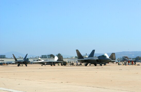 Two F-22 "Raptors" taxi to the runway as they prepare to take off from Marine Corps Air Station Miramar's flight line June 25. For four weeks, Miramar was base to more than 20 visiting aircraft that participated in the Marine Division Tactics Course and exercise Trident Warrior.