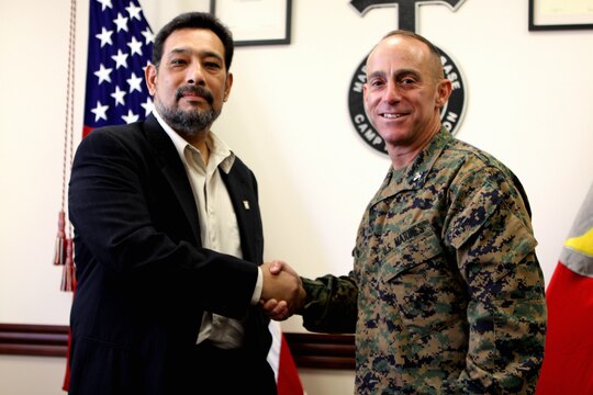 Anthony Reyes (right), president, National Federation of Federal Employees’ Local 919 chapter and maintenance mechanic, Facilities Maintenance Division, Marine Corps Base Camp Pendleton, shakes hands with Col. Nicholas F. Marano, commanding officer, MCB Camp Pendleton, moments after signing a revised labor union agreement, March 10. The new contract will affect nearly 1,200 of the base’s federal employees, who represent a majority of the union bargaining power on base. The base’s rising number of employed civilian personnel prompted revisions to the existing agreement made with the NFFE in 1998.