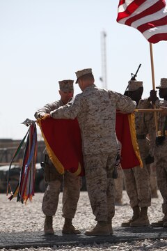 Col. John W. Simons and Sgt. Maj. Craig W. Chaplick case of the colors during a Transfer of Authority ceremony at Camp Leatherneck, Afghanistan, March 24. Casing of the colors symbolizes the completion of CLR-2's mission in Afghanistan, and the start of 1st Marine Logistics Group Forward's authority as the Logistics Combat Element.
