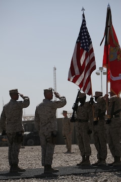 Brig. Gen. Charles L. Hudson, commanding general of 1st Marine Logistics Group Forward, and Sgt. Maj. Antonio N. Vizcarrondo Jr., 1st MLG sergeant major, salute the colors during Combat Logistics Regiment 2 and 1st MLG's Transfer of Authority ceremony at Camp Leatherneck, Afghanistan, March 24. First MLG will begin its mission as the Logistics Combat Element while CLR-2 returns to Camp Lejeune after a nearly year-long deployment.
