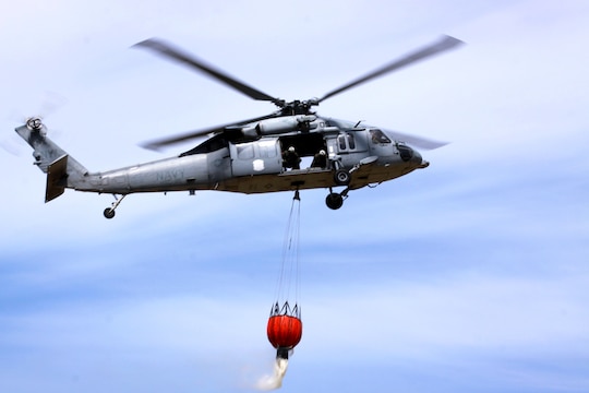 A CH-53E helicopter from 3rd Marine Air Wing, Marine Corps Air Station Miramar, carries its 320-gallon bucket full of water from Las Pulgas Lake during the 3rd annual aerial firefighting effort at Camp Pendleton, May 13. Approximately 34 emergency service personnel and several aircraft from Marine Corps Base Camp Pendleton, Marine Corps Air Station Miramar, Naval Air Station North Island and California’s Department of Fire and Forestry Protection (CAL FIRE) extinguished simulated fires on base by coordinating helicopter water drops.