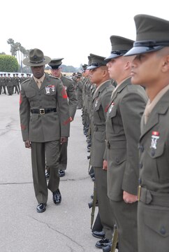 Sgt. James Ramsey and 1st Lt. Christopher Edwards march down first squad to inspect another recruit from platoon 1033.