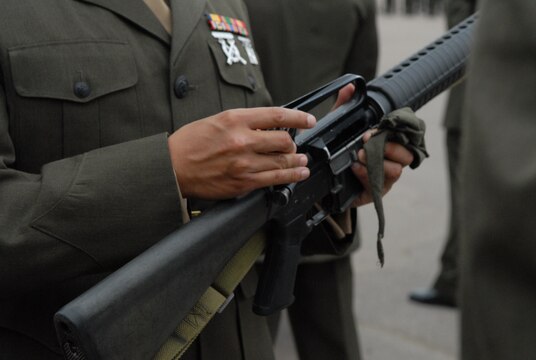 An inspecting officer closely inspects a recruit's rifle for any dirt, grease or left over carbon from the rifle range and excess lubricant