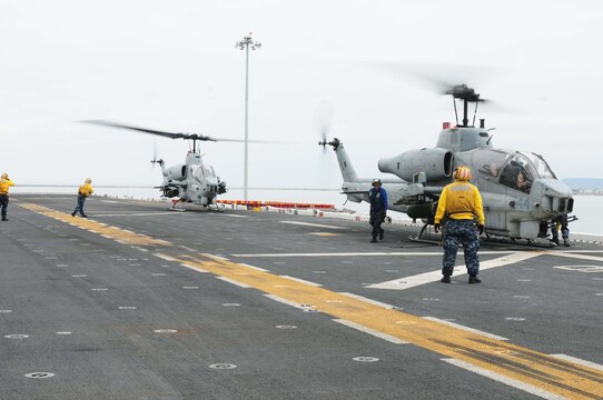 Two AH-1W "Cobras" with Marine Medium Helicopter Squadron 165 (Reinforced) land on the USS Peleliu docked at Naval Base San Diego May 17, 2010. HMM-165 (Rein) is preparing to ship out with the 15th Marine Expeditionary Unit on May 20, 2010, to the Western Pacific for a seven-month deployment.::r::::n::
