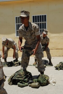 Private First Class Duy Trinh checks his gear to make sure it is serviceable and all accounted for before returning it to the property control office.