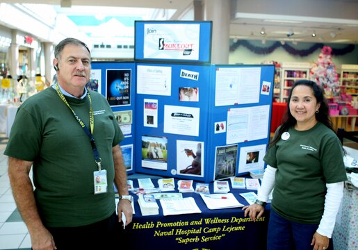 John Swett Jr., a health educator and Tobacco Cessation Program coordinator with the Health Promotion & Wellness, Naval Hospital Camp Lejeune, and Loida Householder, a promotion specialist with Health Promotion, take a moment to pose in front of their informational booth on tobacco and nicotine during the Great American Smokeout at the Marine Corps Exchange aboard Marine Corps Base Camp Lejeune, Nov. 18.::r::::n::The Smokeout is an annual event held on the third Thursday of November in locations across the nation, raising nicotine awareness and encouraging millions of Americans to stop smoking.