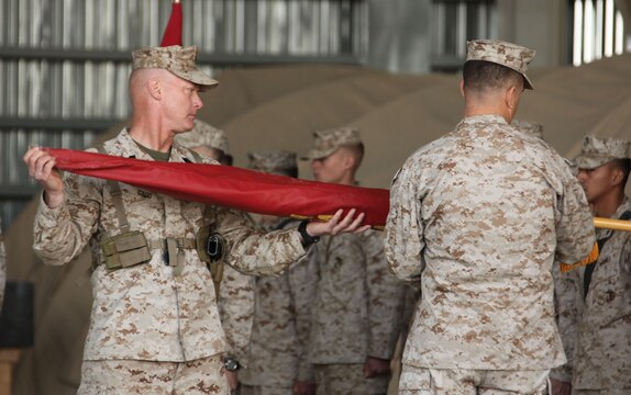Lt. Col. John Bolt, the commanding officer of Marine Fighter Attack Squadron 122, 3rd Marine Aircraft Wing (Forward), and Sgt. Maj. David Cadd, the squadron sergeant major, uncase the squadron colors during a transfer of authority ceremony held at Kandahar Air Field, Afghanistan, Nov. 20.  VMFA-232 relinquished their area of responsibility to VMFA-122, after having supported coalition forces in Helmand and Nimroz provinces for the past six months.