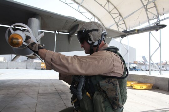 Lt. Col. Daniel Shipley, the commanding officer of Marine Fighter Attack Squadron 232, 3rd Marine Aircraft Wing (Forward), checks over his F/A-18C Hornet at Kandahar Air Field before a flight.  On Nov. 4, seven F/A-18s such as this one were used in a preplanned precision strike against known insurgent firing points and weapons caches at Kajaki Dam.  Throughout the course of the day, 14,000 pounds of ordnance were dropped on 21 predetermined locations.